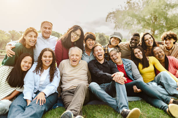 Diverse group of people laughing together in a park
